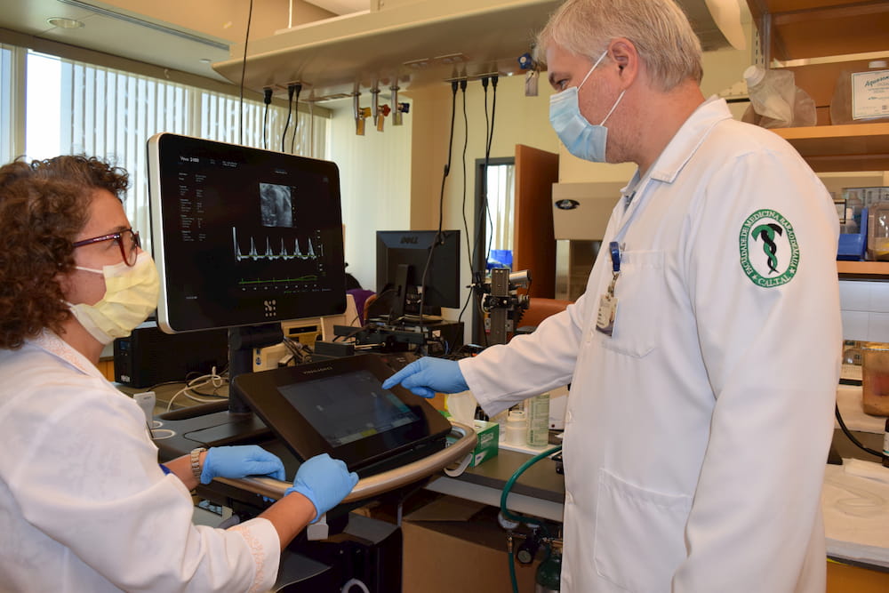 Ultrasonography Imaging Core participants look at equipment.